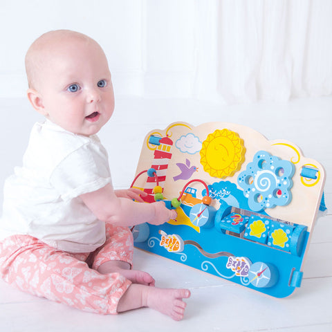 Baby playing with Marine Activity Centre sensory busy board