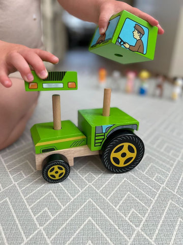 Boy playing with Stacking Tractor Toy