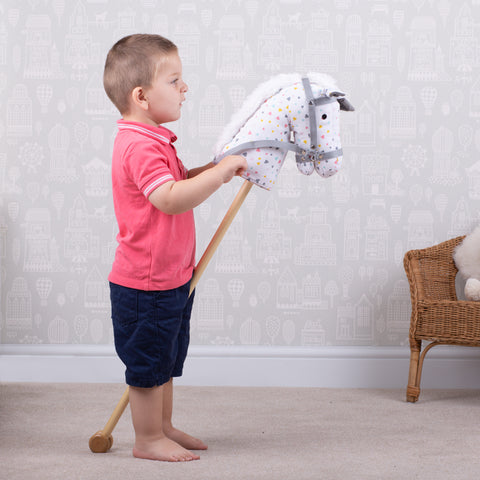 Boy playing with Patterned Hobby Horse
