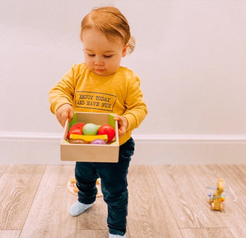 Boy playing with Wooden Fruit Crate
