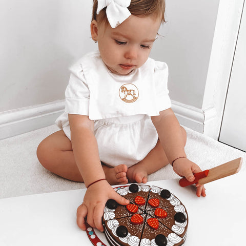 Girl playing with Chocolate Cake food toy