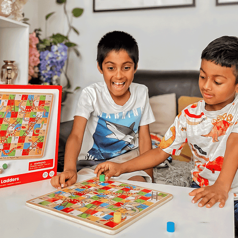 Boys playing Snakes and Ladders 