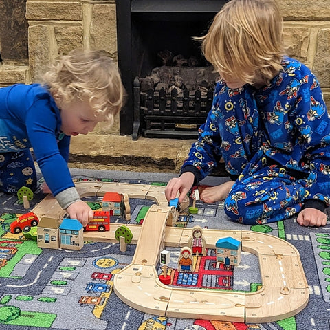 Kids playing with Roadway Race Day track