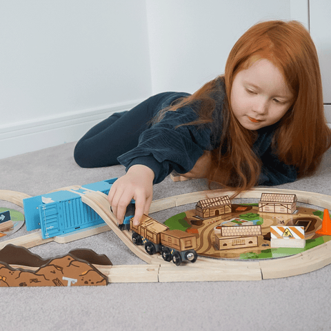 Girl playing with Construction Train Set