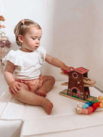 Little girl playing with Pixie Dust Tree House