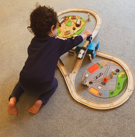 Boy playing with Construction Train Set