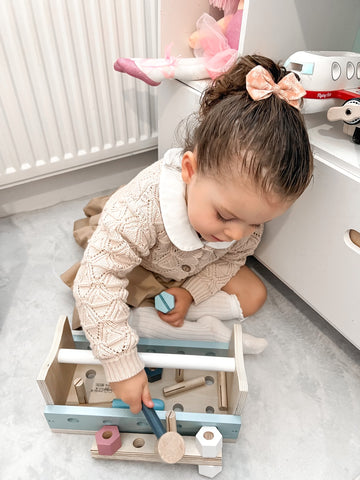 Toddler playing with Wooden Work Bench