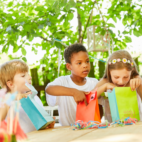 Children opening up their party bags