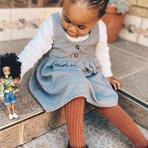 Girl playing with Kid Activist Lottie Doll