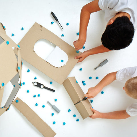 Boy playing with Makedo tools