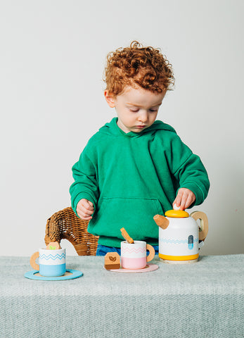 Toddler playing with Tea For Two imaginative play set
