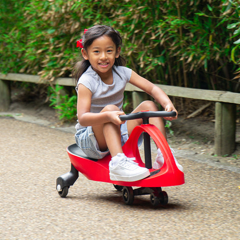Girl riding Fiery Red Didicar ride on toy