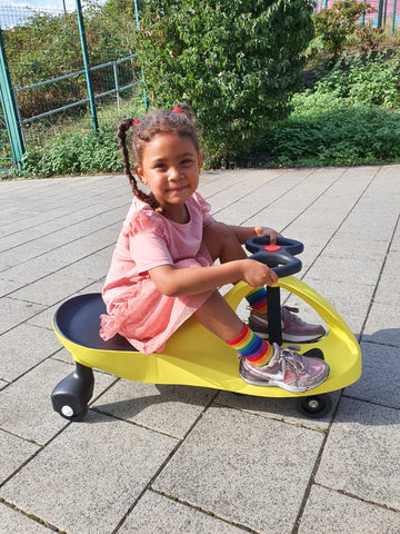 Ride on toys: Girl riding her yellow Didicar