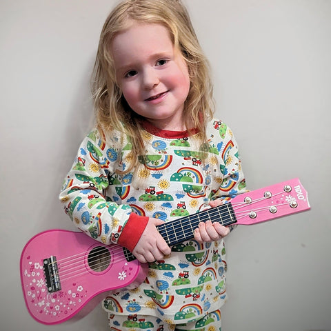 Little girl playing with Tidlo Guitar