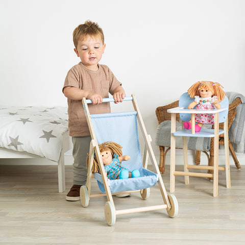 Boy enjoying imaginative play with doll and pram