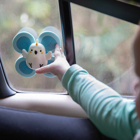 Child playing with Sensory Spinners travel toy in the car