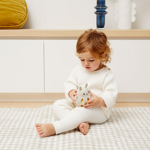 Girl playing with Silicone Bunny Rattle