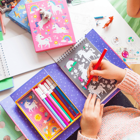 Child enjoying some unicorn colouring with Tiger Tribe set