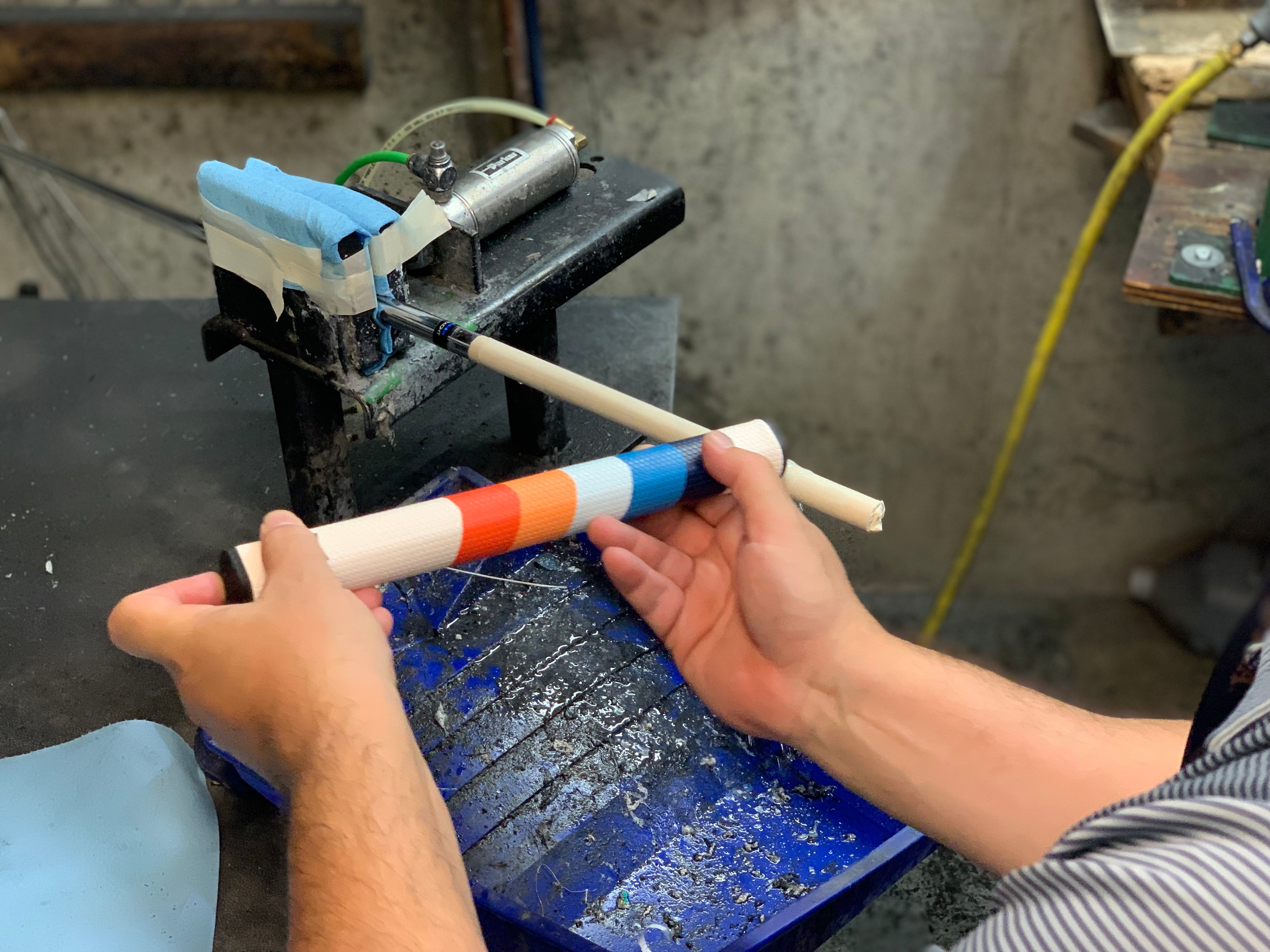 Applying solvent to a new grip when regripping a golf club.