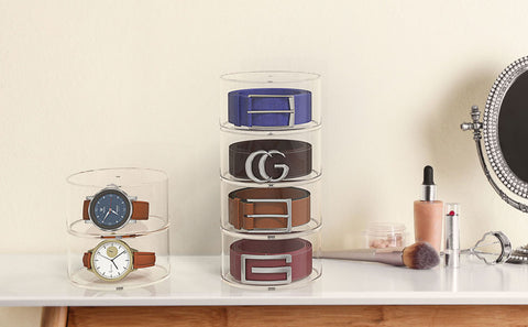 Belt organizer on dresser top with belts and watches