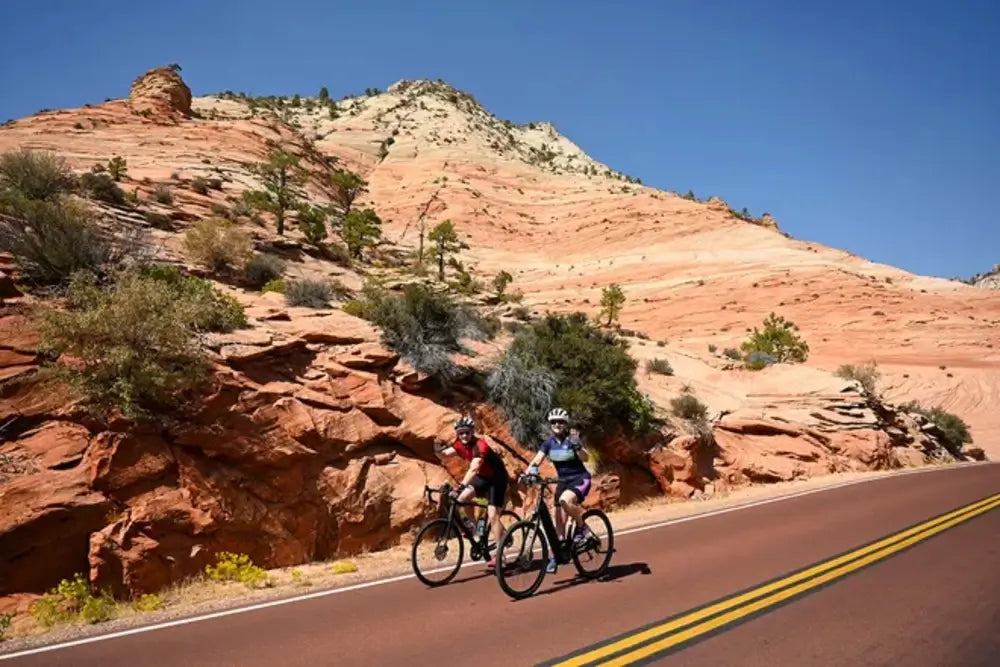 Two riders on electric bikes with proper riding gear