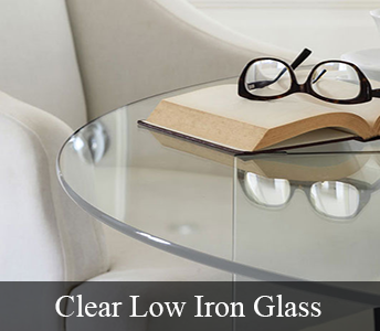 Clear Low Iron Glass Table Top with a pair of glasses on top of a book sitting on the table