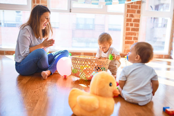 A mother doing activities with her toddlers for speech development