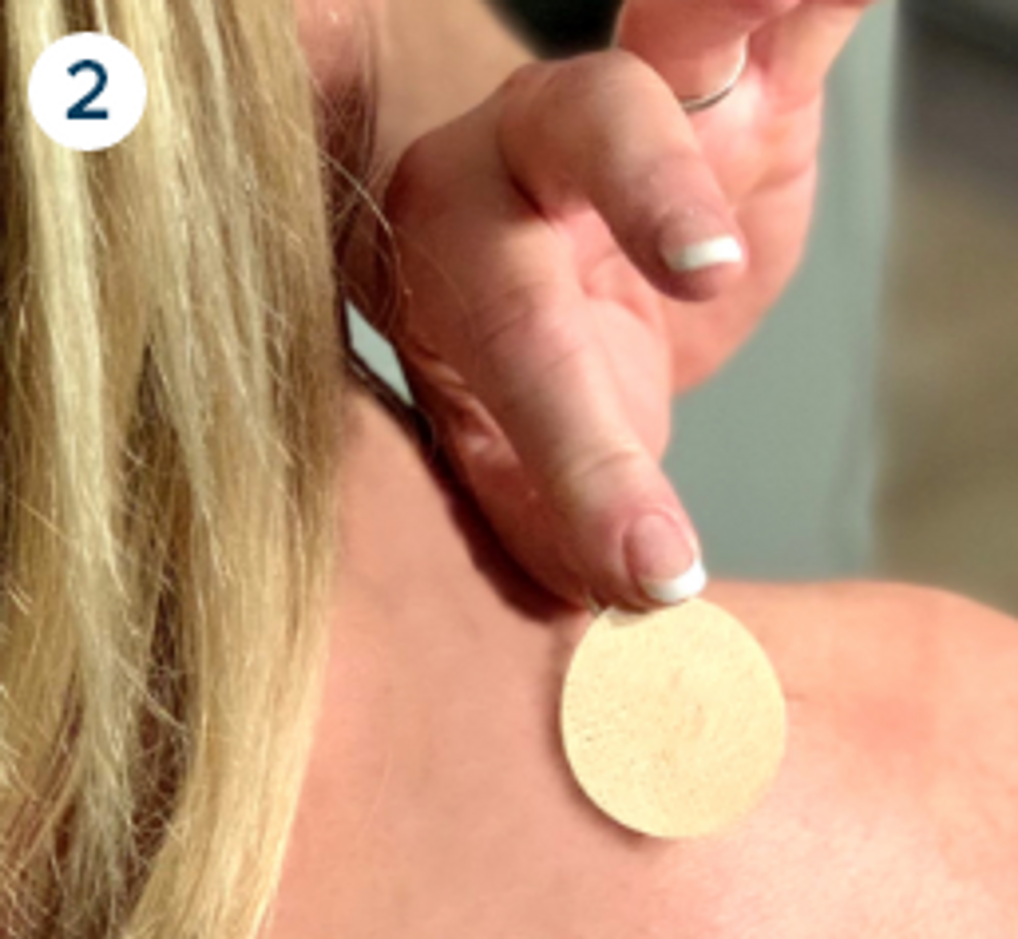  using the left thumb and left index finger, the patch is applied on the right shoulder