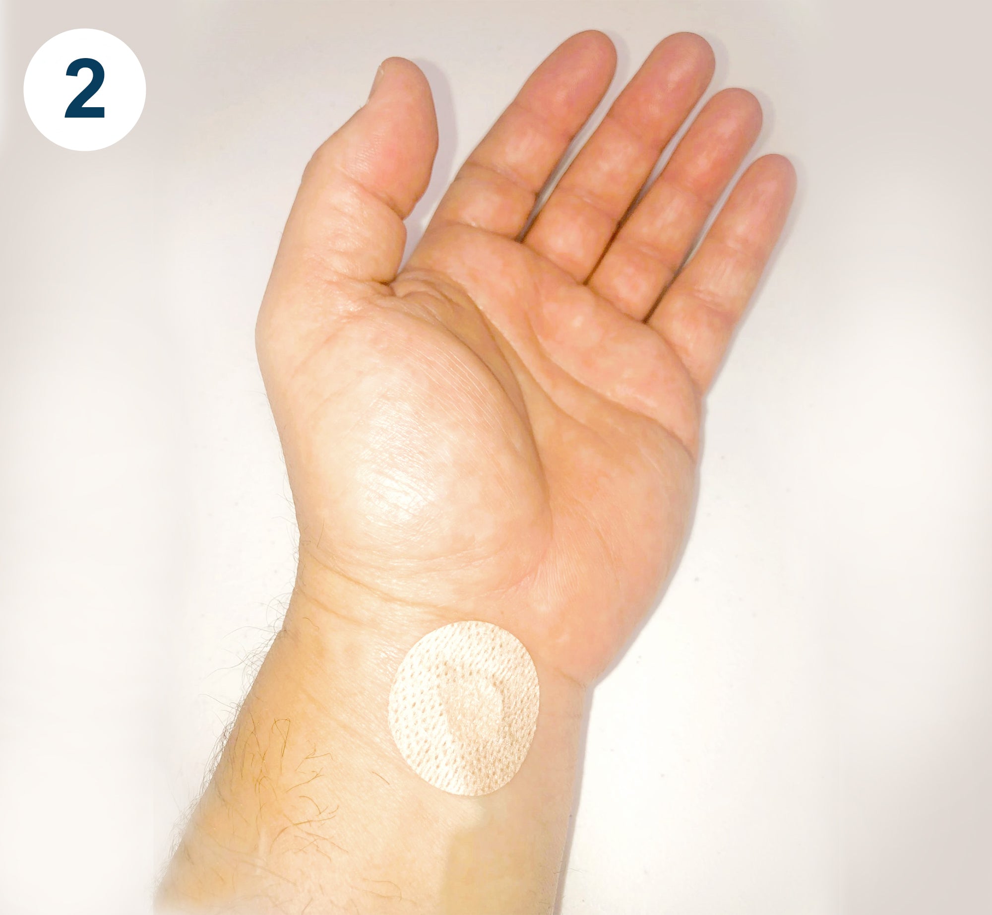 thumbs and index fingers from both hands are used to peel the adhesive from the patch