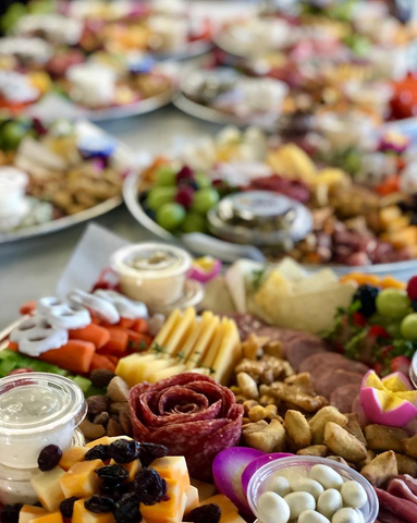 grazing platters with meats, cheeses, and fruits