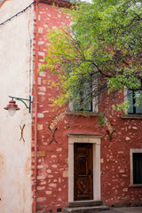red painted house in roussillon, provence, france