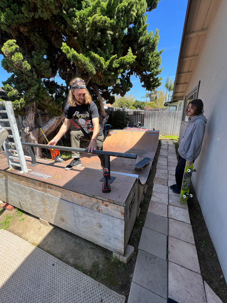 OC Ramps skate rail on halfpipe with pro skaters