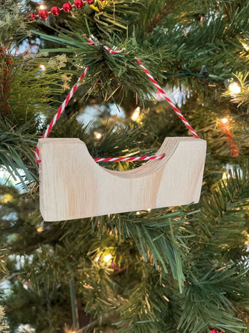Vertical photo of the OC Ramps Half Pipe Ornament on a tree