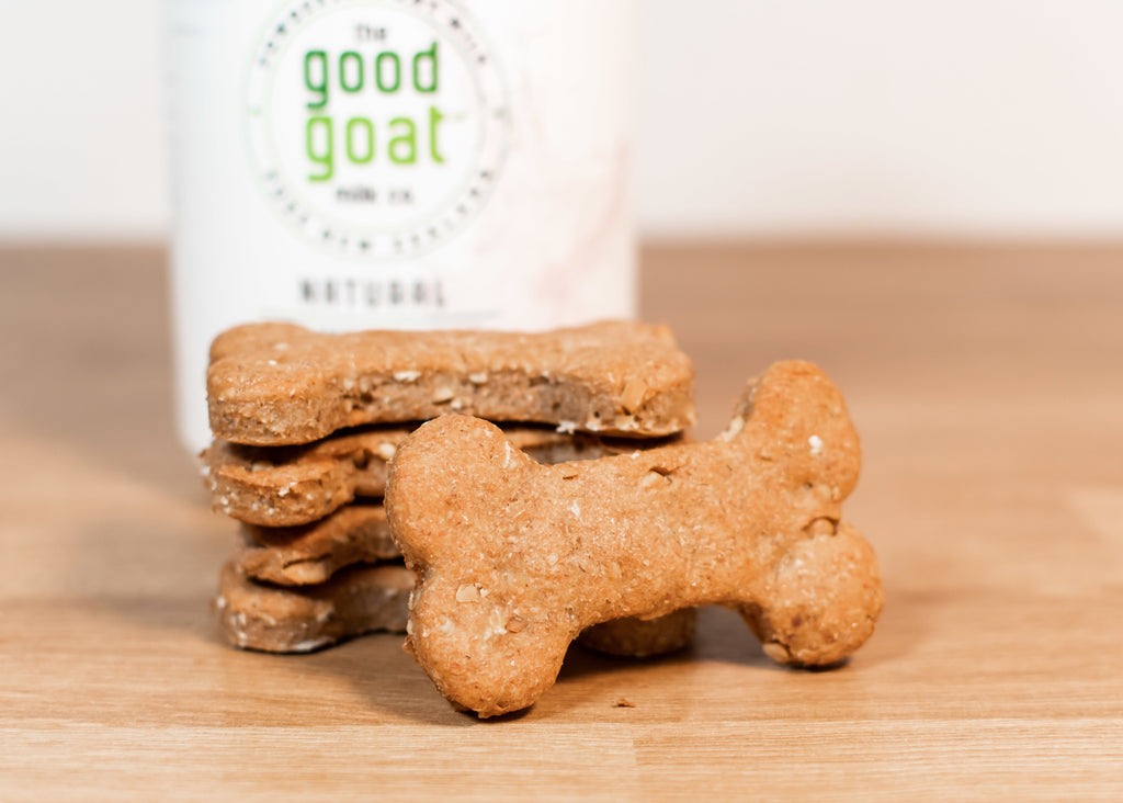 a stack of goat milk homemade dog treats with good goat milk container behind