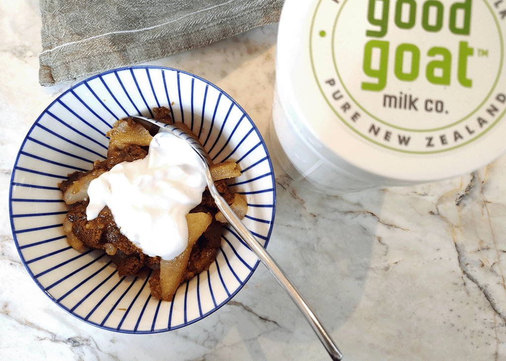 Pear bottom gingerbread in a blue and white bowl with a dollop of coconut yogurt on top.
