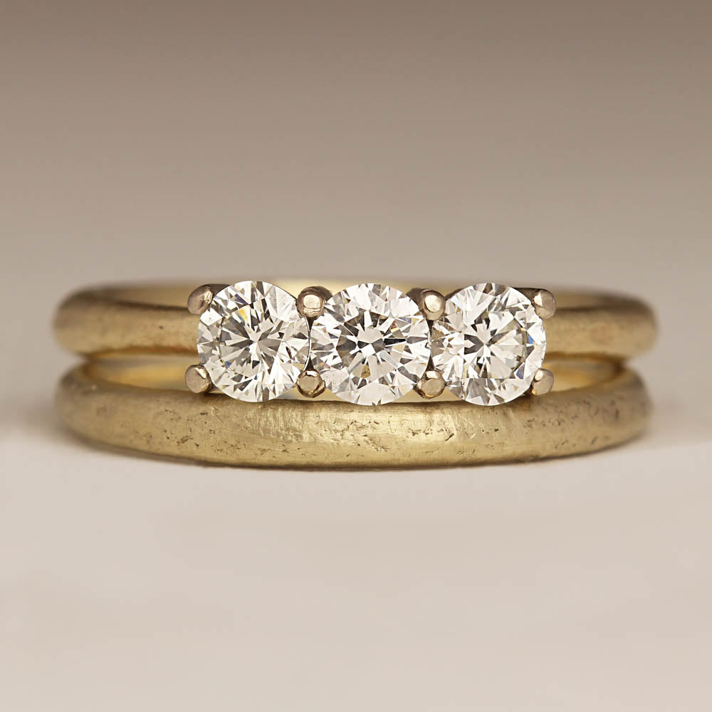 Three stone diamond engagement ring and match wedding band