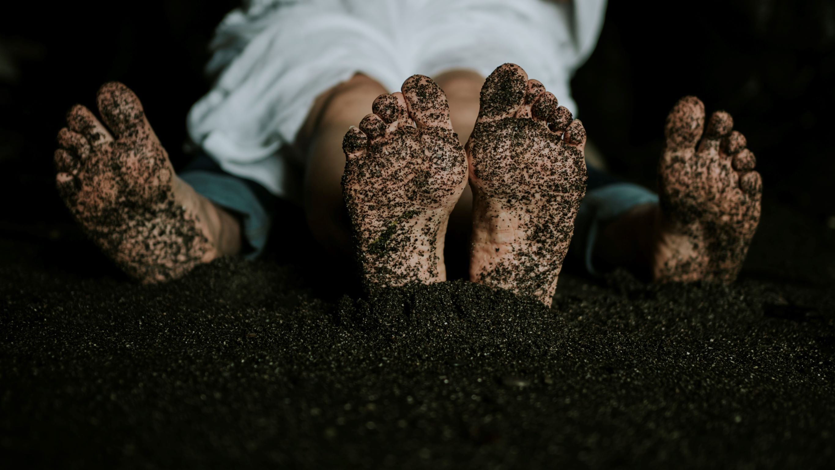 Sandy feet of newly engaged couple 