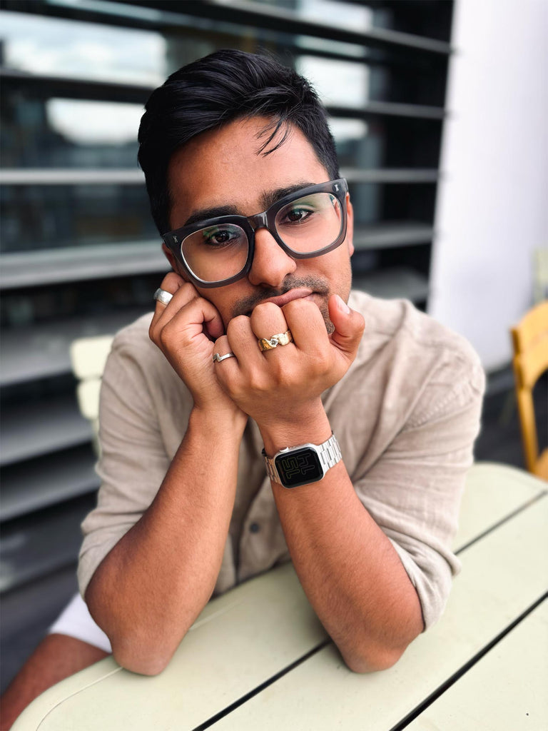 Young man wearing a saandcast diamond ring, it's made from heirloom gold cast in beach sand with a ruuged organic look that contrasts with the bright sparkling diamond.