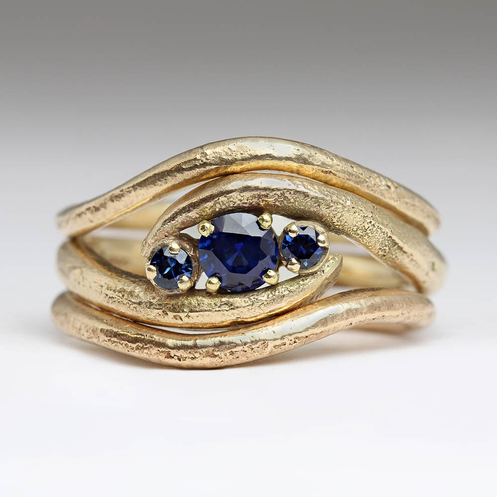 Sapphire wave engagement ring with two shaped wedding bands