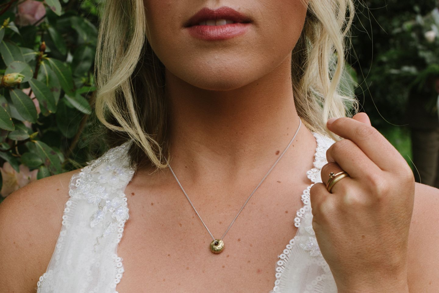 Personalised bridal pendant, gold bead cast in beach sand hangs on a contrasting chain. Sandcast wedding and engagement ring