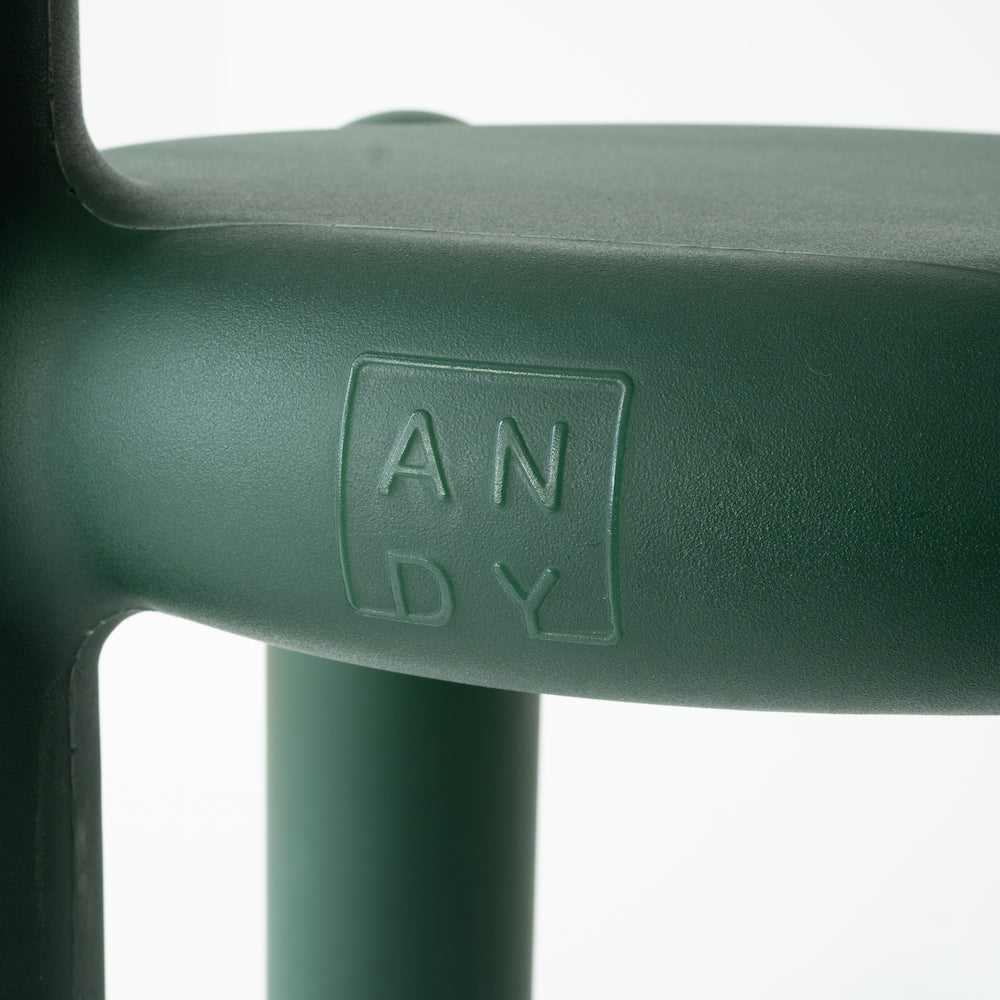 Close-up of a green chair with the name 'ANDY' embossed on it.