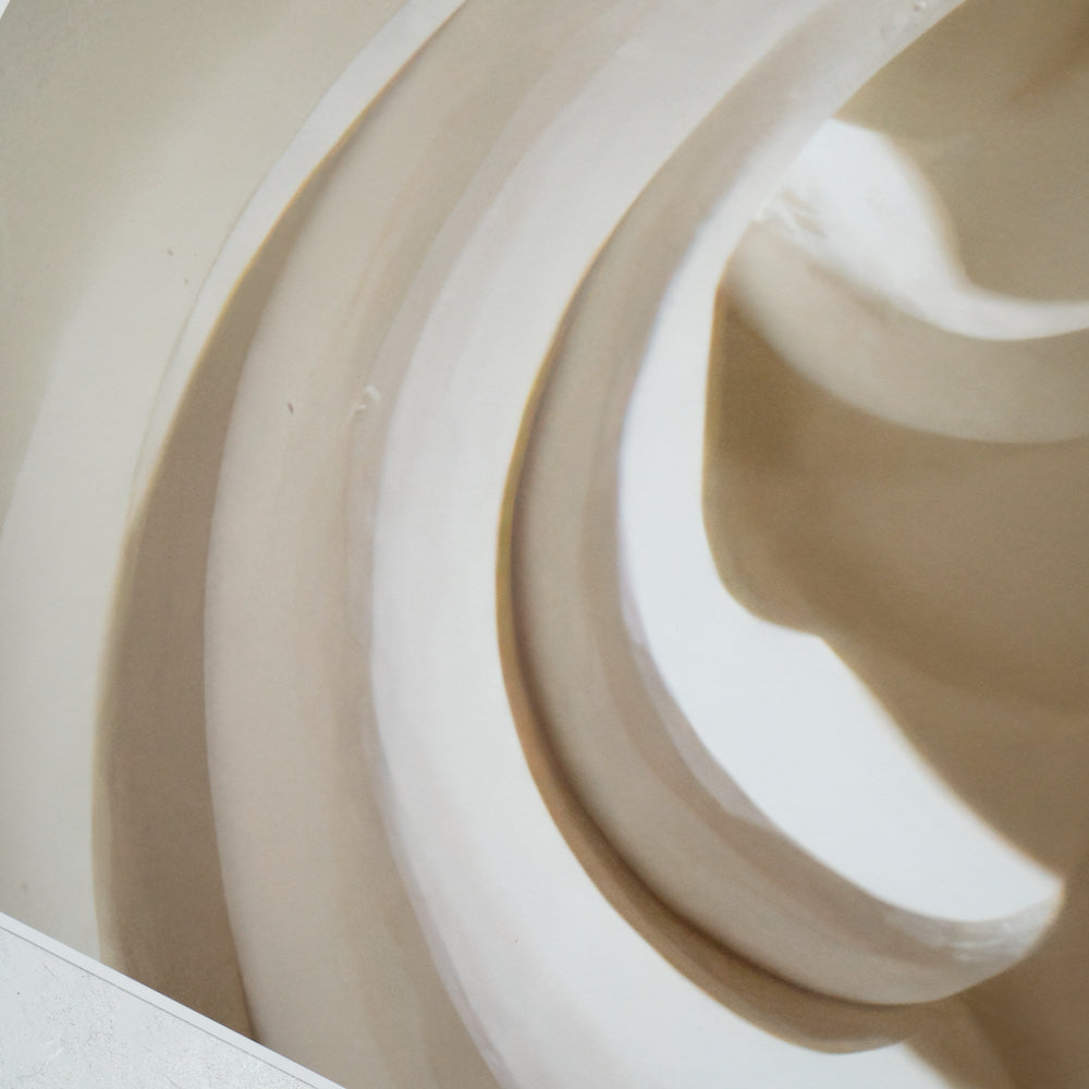 Close-up of white concentric abstract sculpture curves.