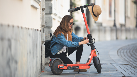 Woman locking an electric scooter