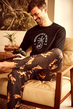 Model in plain woven cotton pyjama bottoms and a long-sleeve t-shirt