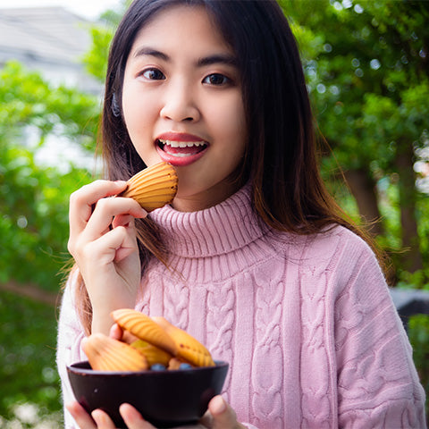 Image of a person eating madeleines