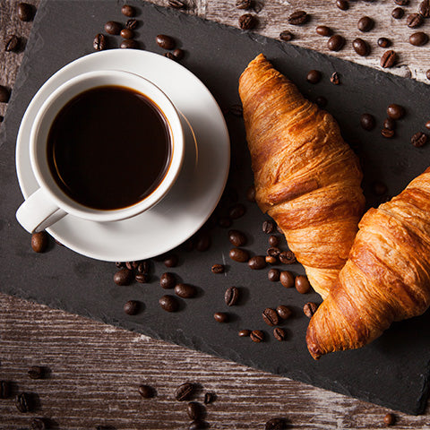 Image of croissant and black coffee