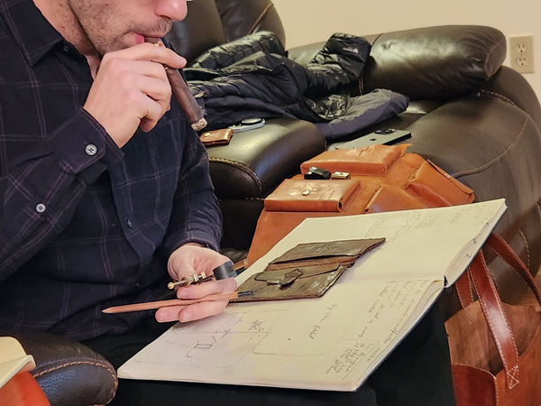 Aaron Aiken sketching the leather wallet replica