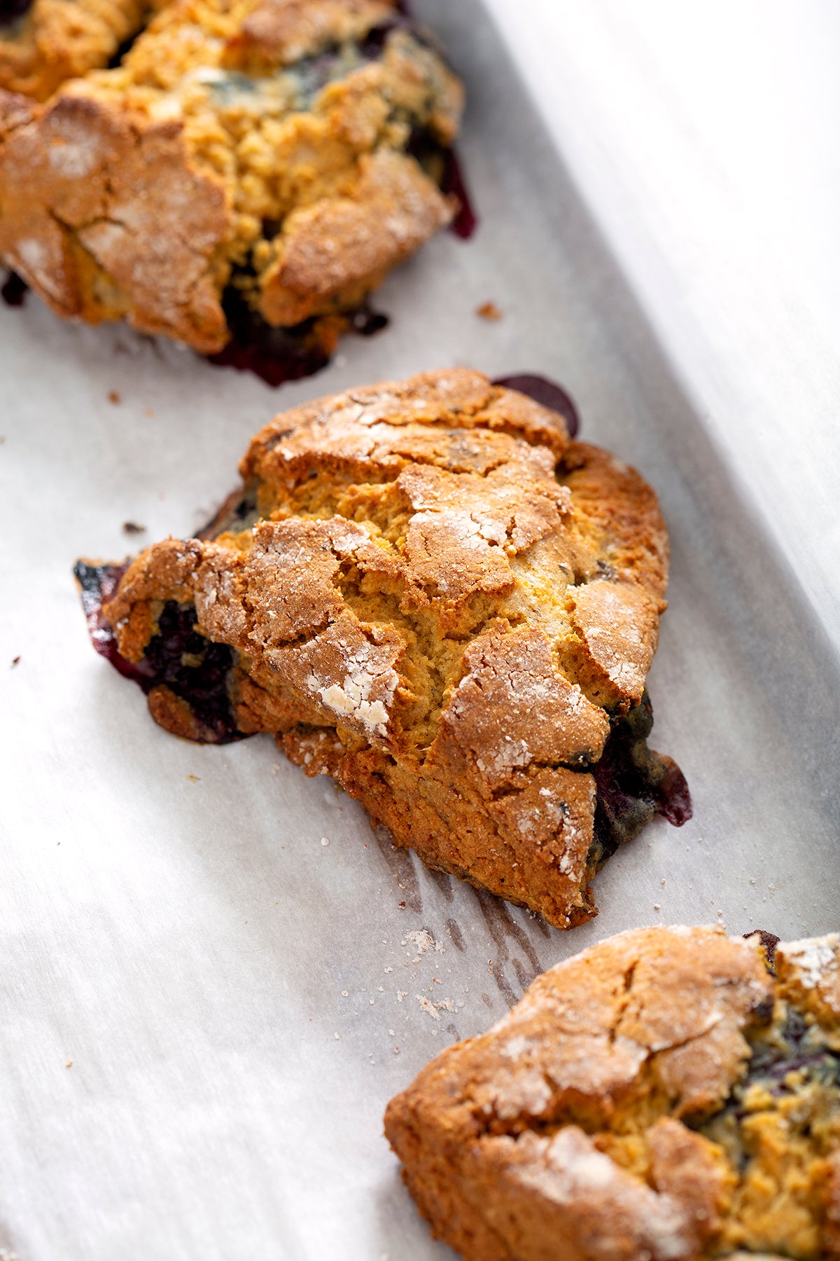 gluten free blackberry scones on parchment lined baking sheet