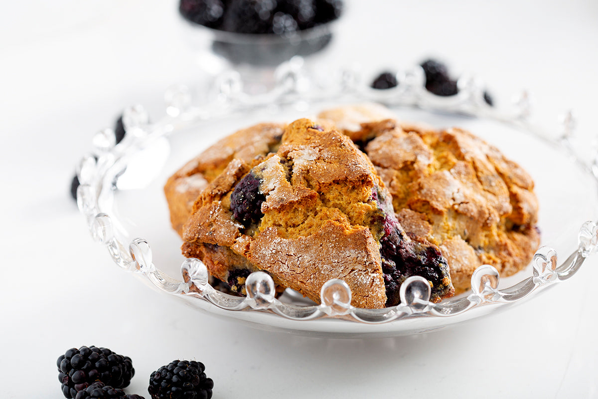 gluten free blackberry scones in bowl with blackberries on counter