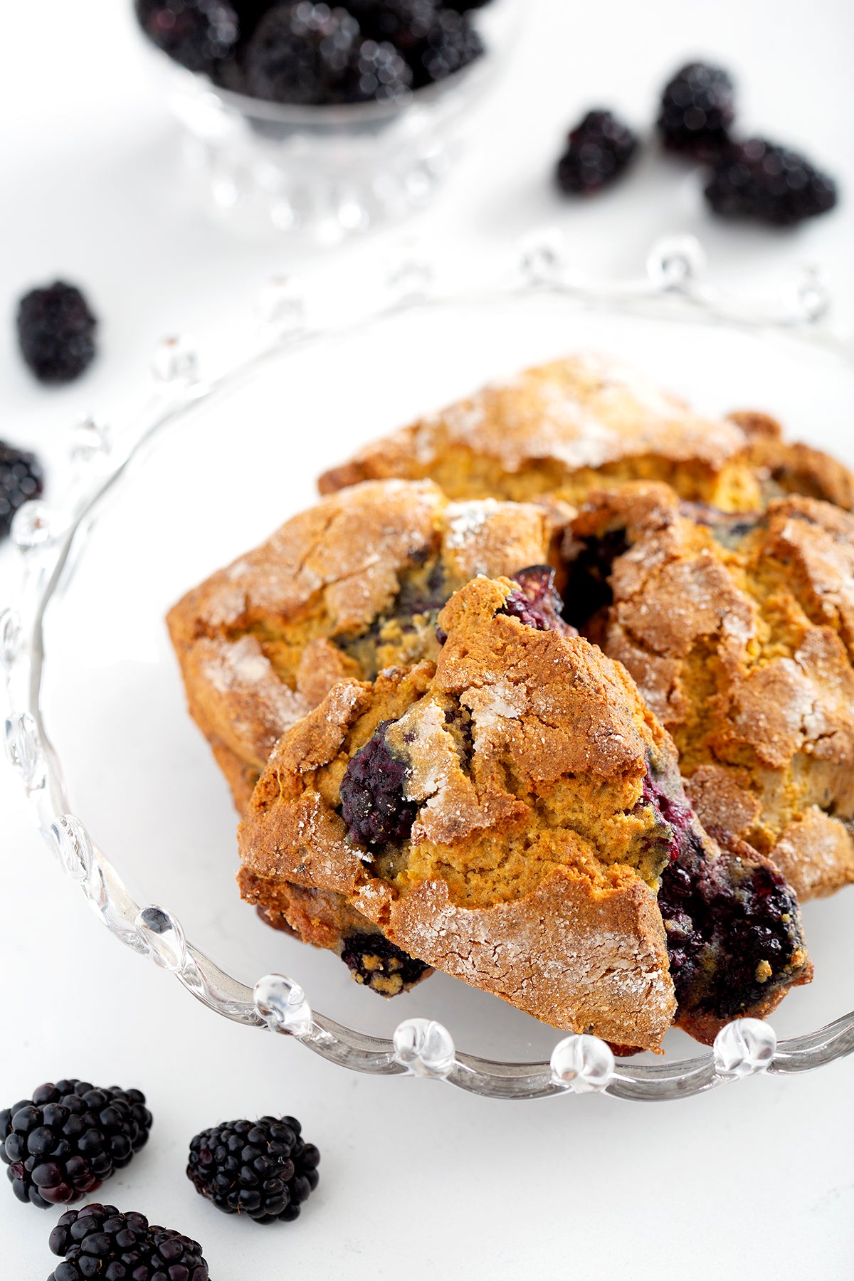 bowl of gluten free blackberry scones with blackberries on counter